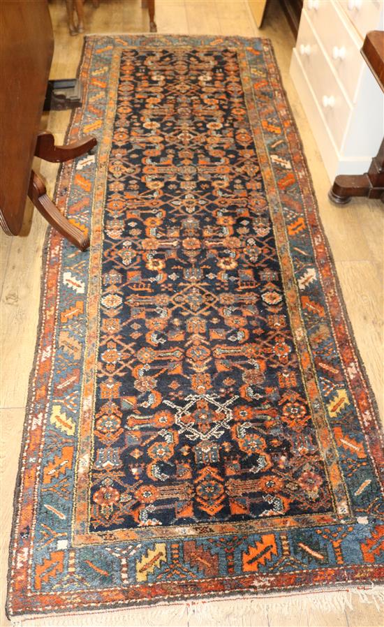 A Caucasian black ground hall carpet 294 x 105cm